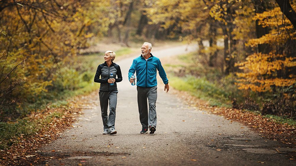 Man and woman hiking in the woods.